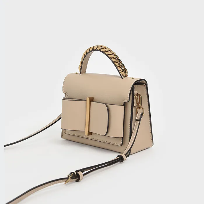 Túi Cầm Tay Nữ Charles & Keith CNK Chunky Metal Top Handle Bow Flap Bag CK2-50680795-1 Màu Be