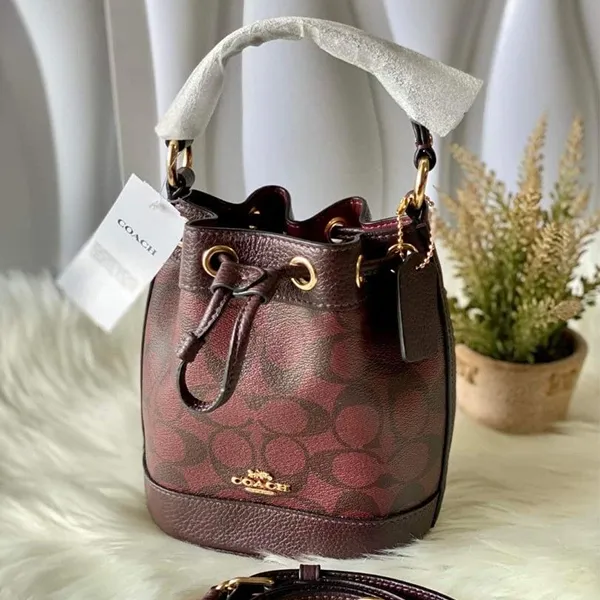 Túi Đeo Chéo Nữ Coach Dempsey Drawstring Bucket Bag Màu Đỏ Nâu